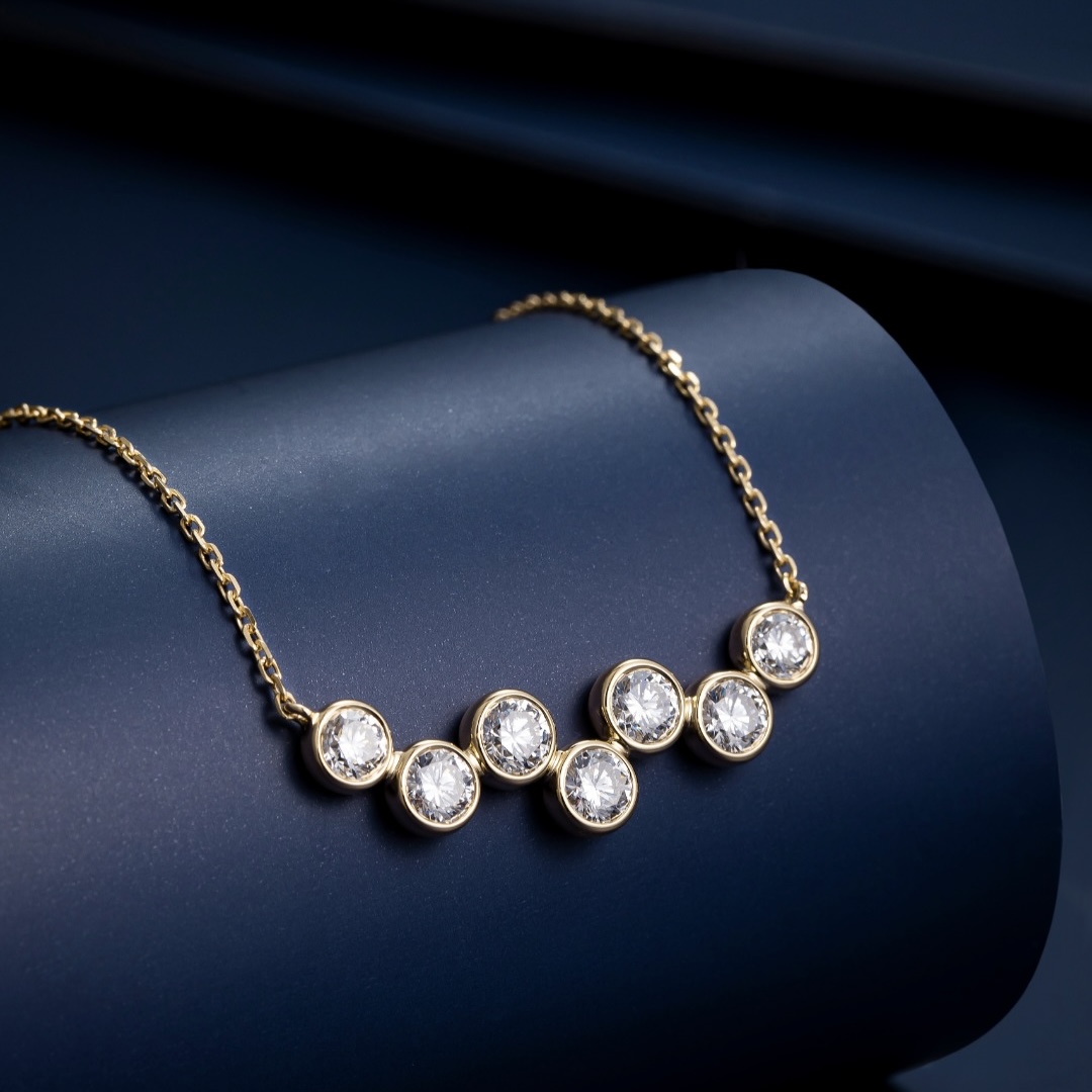 A bezel-set lab-grown diamond necklace in yellow gold